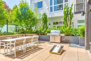 an outdoor patio with tables and chairs and a grill at Wilcox, Washington